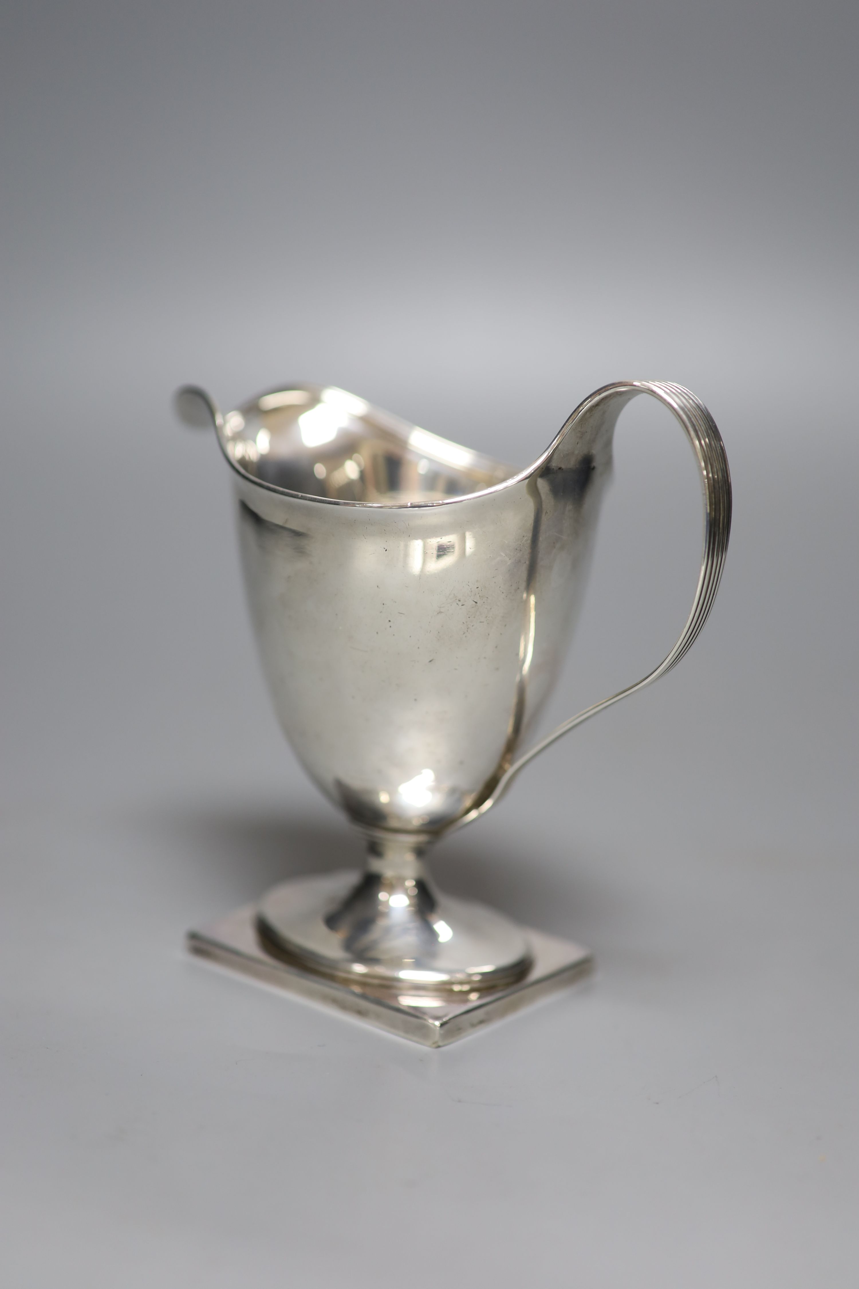 A George III silver helmet shaped pedestal cream jug, Henry Chawner, London, 1795, 13.4cm, 5.5oz